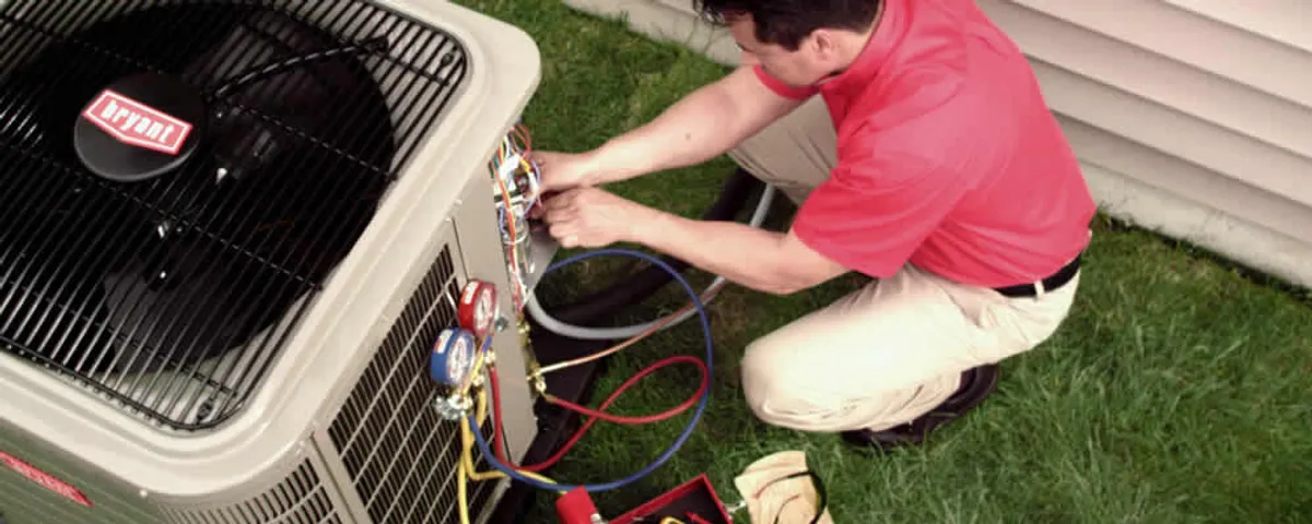 HVAC technician servicing an outdoor air conditioner unit in Seattle, WA
