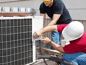 HVAC technicians repairing an outdoor AC unit on a rooftop in Seattle, WA